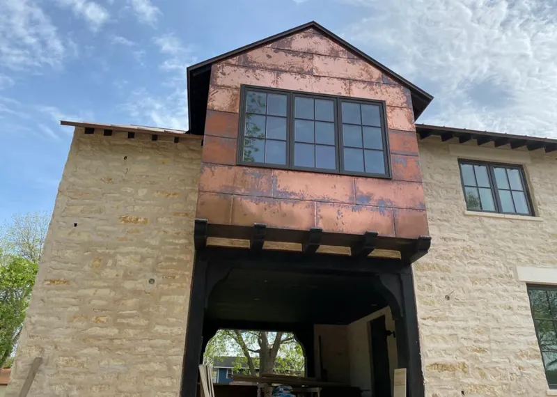 Copper metal panel facade on a stone building for Metal Roof Coating in Orange